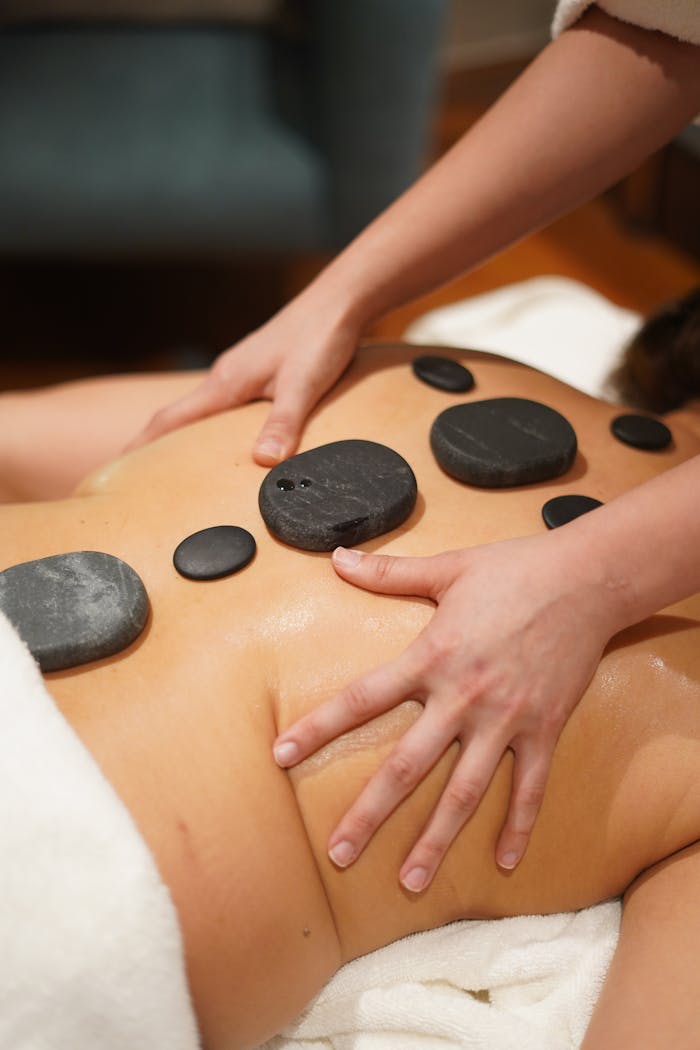 A calming hot stone massage at an Islamabad spa, ideal for stress relief and relaxation.